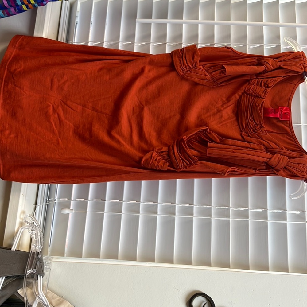 Nice unique top that possibly be worn as a super mini dress.